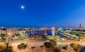 Panoramic night-time view of Port Vell from the hotel